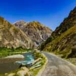 Green and brown mountains beside a river in Pakistan
