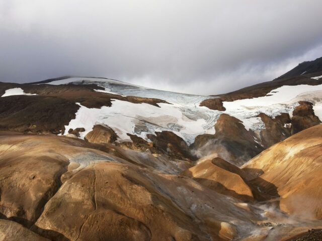 A glacier atop an arid, rocky landscape, similar to the moraine terrain of Baltoro Glacier
