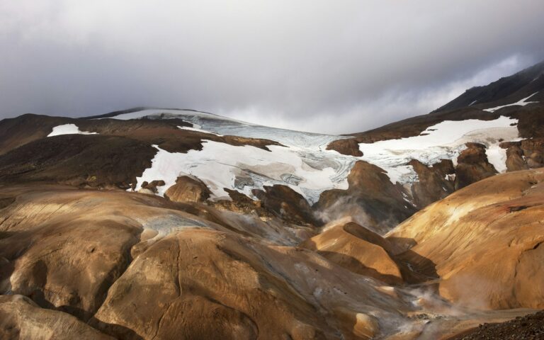A glacier atop an arid, rocky landscape, similar to the moraine terrain of Baltoro Glacier
