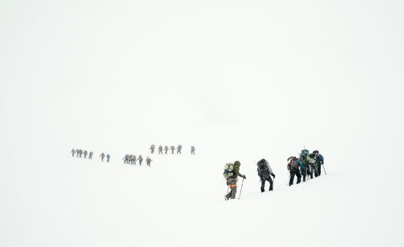 Hiring a guide in northern Pakistan: a guided group crossing a snowy mountain