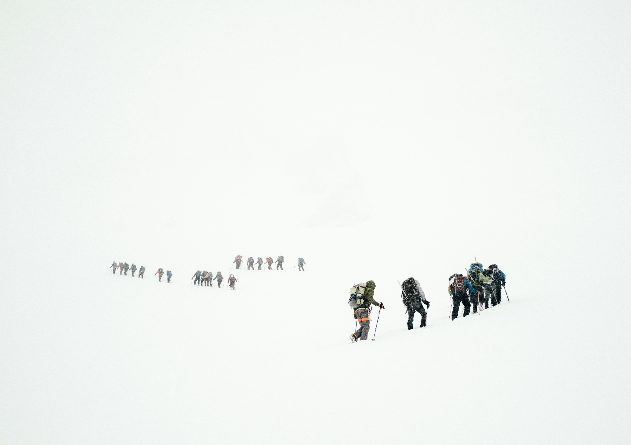 Hiring a guide in northern Pakistan: a guided group crossing a snowy mountain