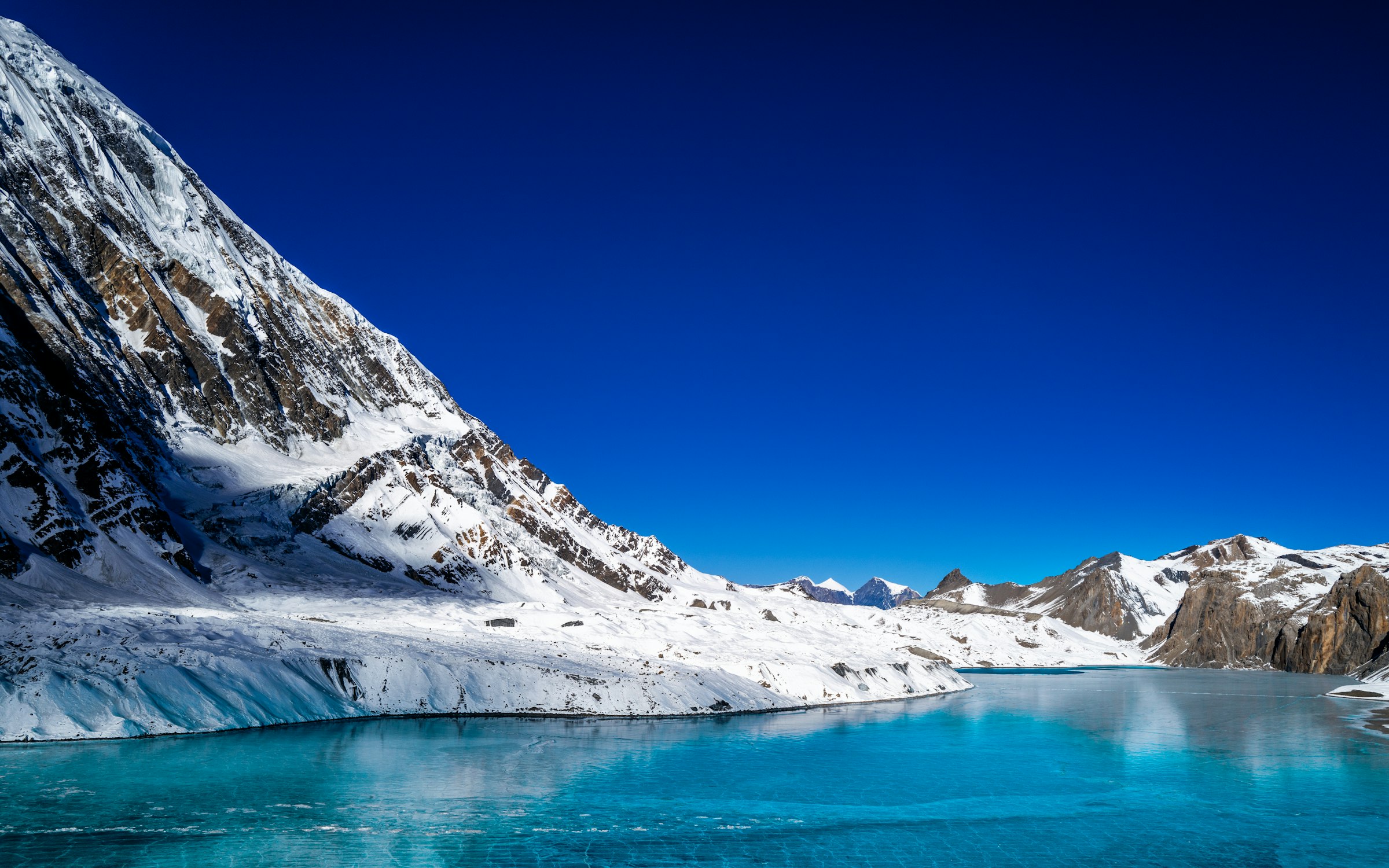 A high-altitude glacial lake surrounded by snow-capped peaks, similar to Rush Lake