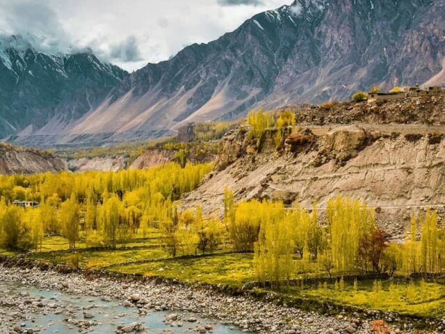 Green and brown mountains in Hunza under white clouds