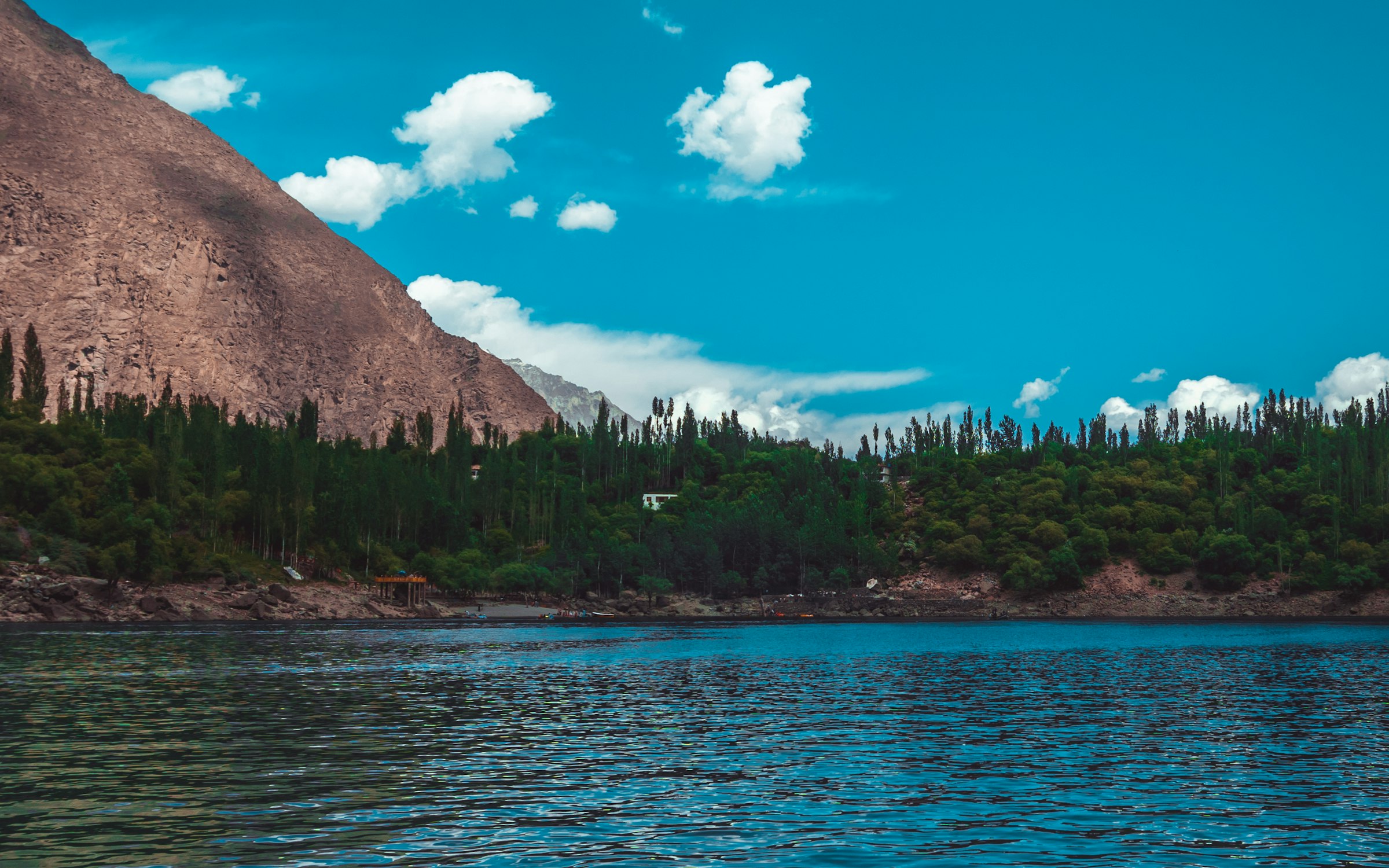 Boating on a mountain lake near Skardu, similar to activities at Satpara Lake