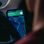 Using a ride-hailing app on a smartphone inside a car