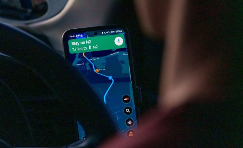 Using a ride-hailing app on a smartphone inside a car