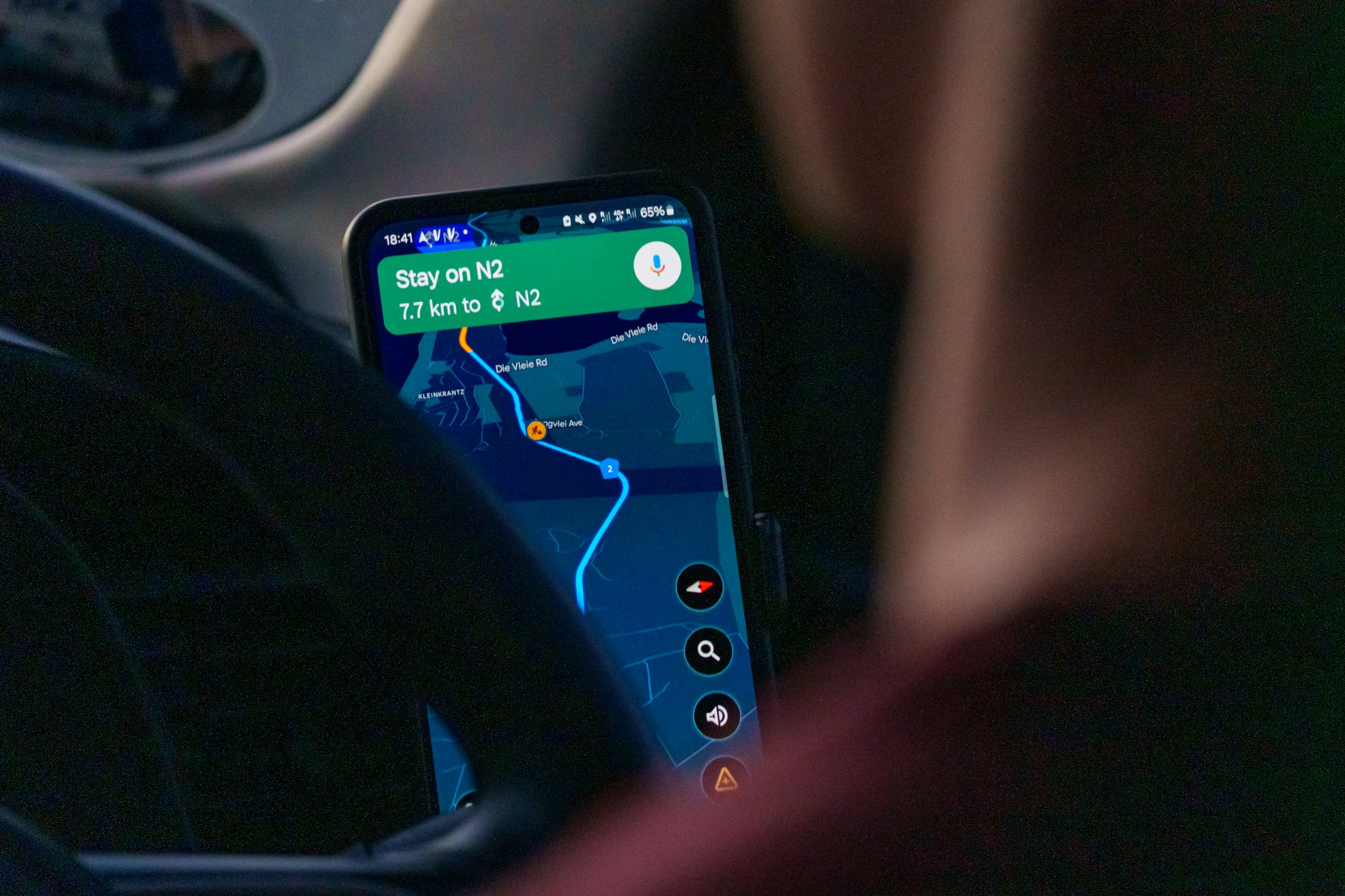 Using a ride-hailing app on a smartphone inside a car