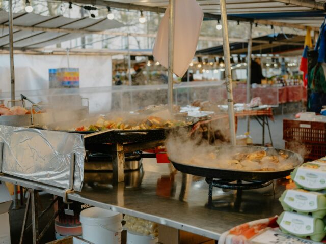 Food stalls cooking fresh at an outdoor market, illustrative of street food safety practices