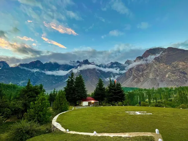 A grassy terraced field with mountains in the background, near Skardu, Pakistan