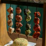 Grilled meat skewers served with rice and naan bread, illustrative of Peshawari kabab dishes
