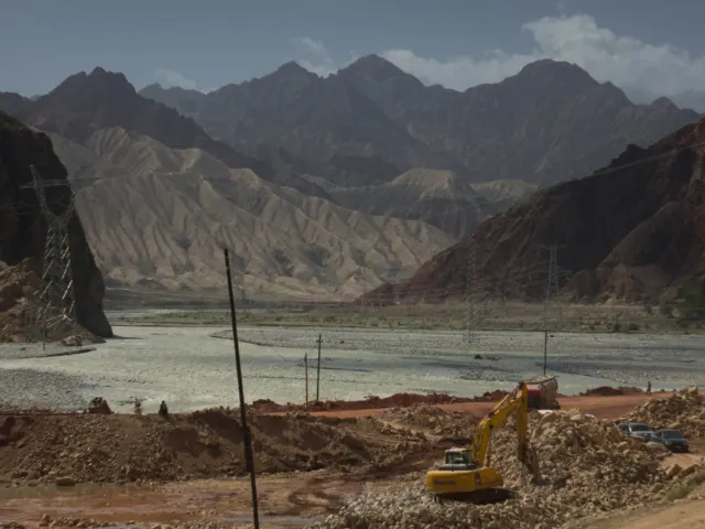A truck driving along the Karakoram Highway near mountains, the route to Sost Dry Port and the China border, Pakistan