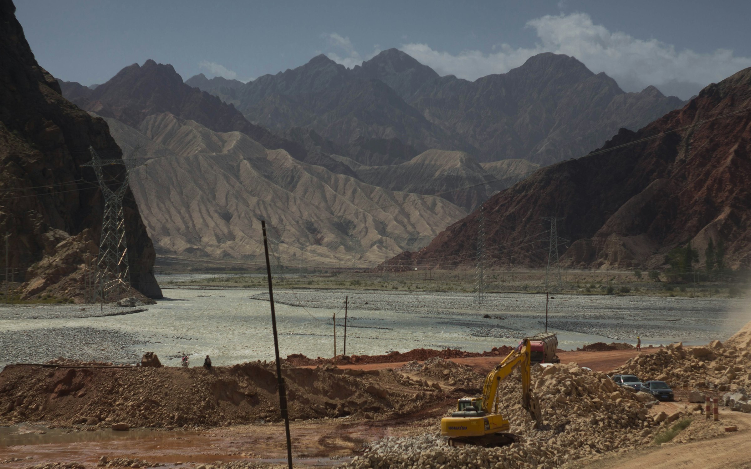 A truck driving along the Karakoram Highway near mountains, the route to Sost Dry Port and the China border, Pakistan