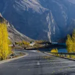 A concrete road winding through mountains, illustrative of self-drive routes in Pakistan