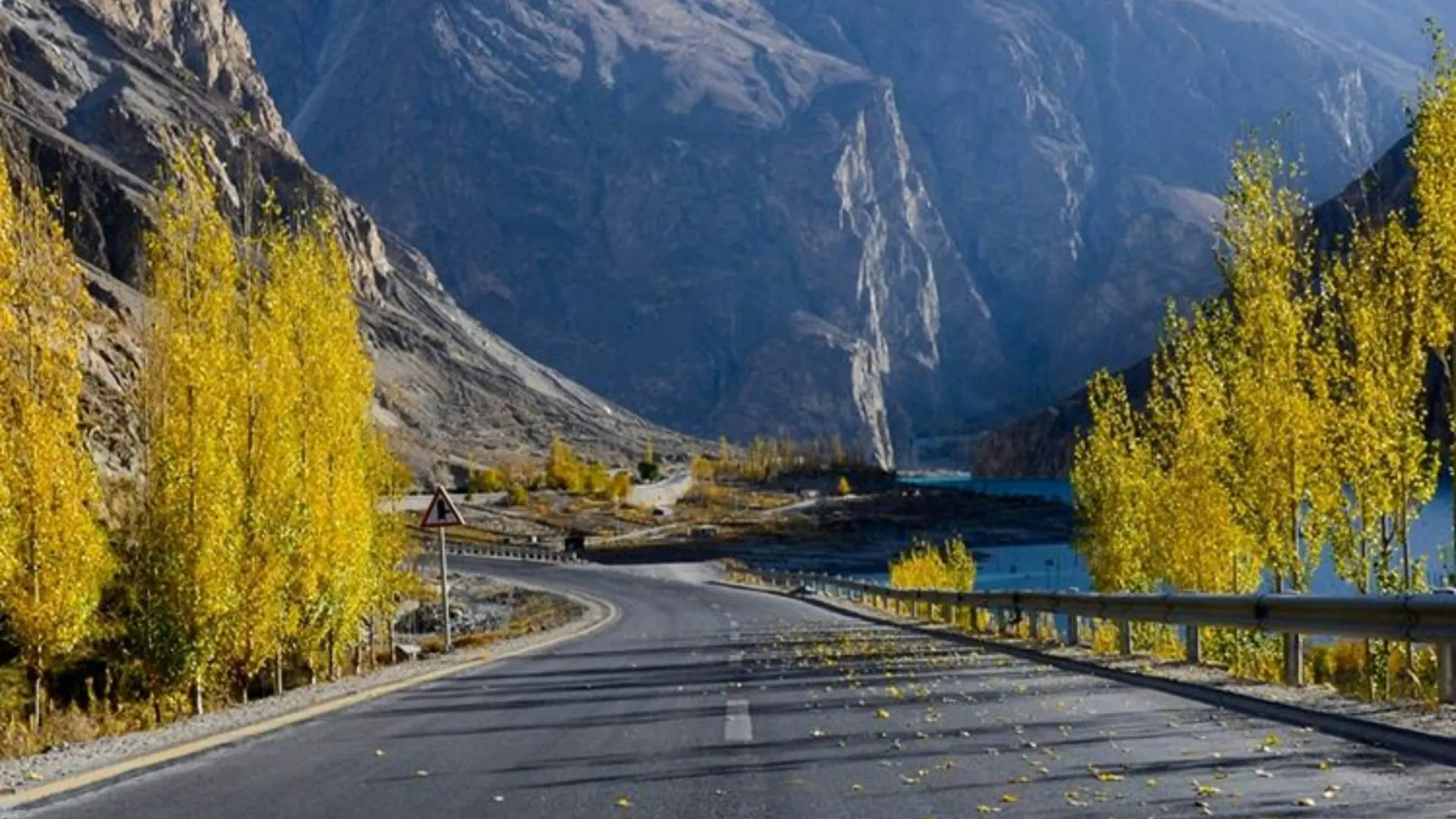 A concrete road winding through mountains, illustrative of self-drive routes in Pakistan