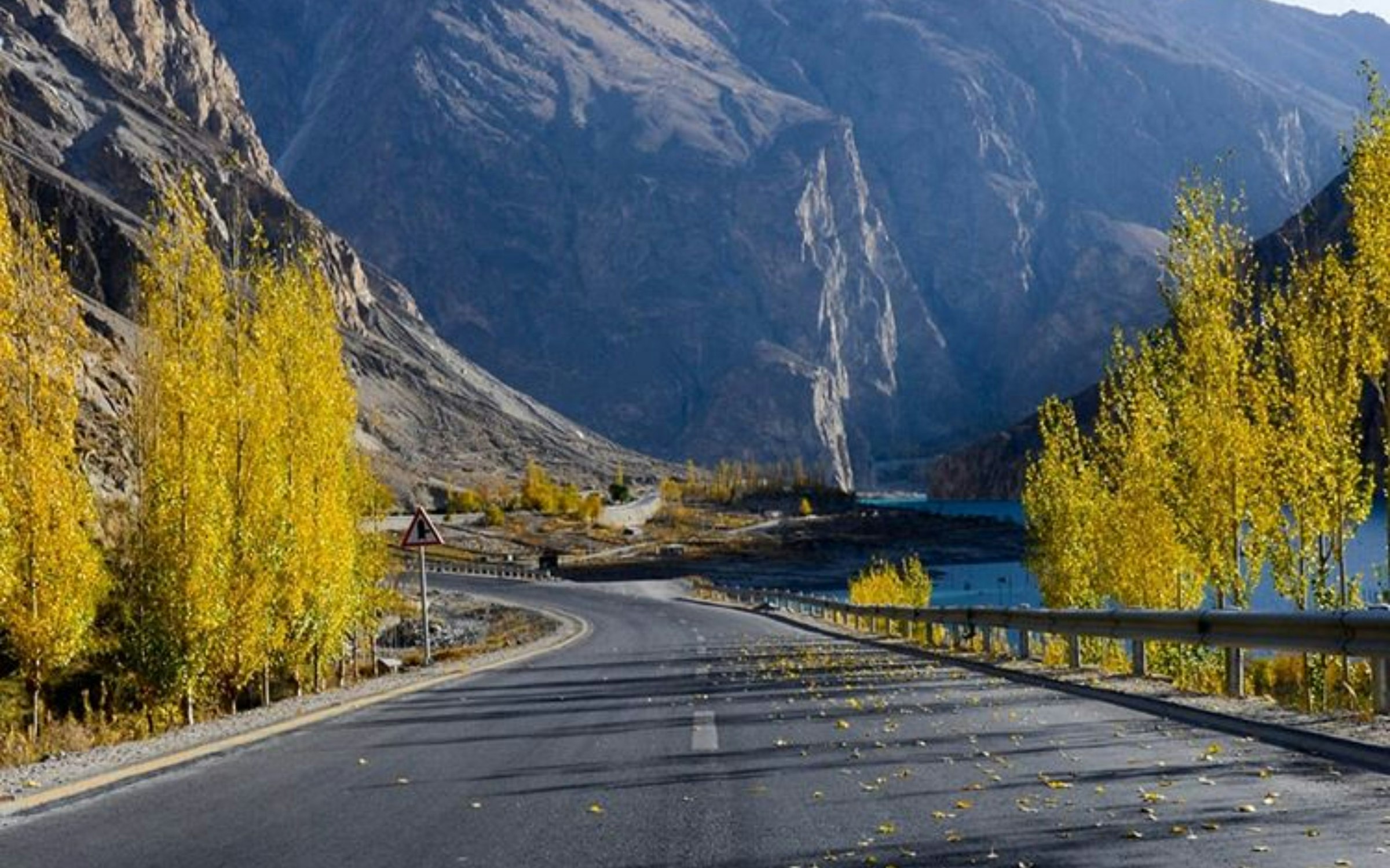 A concrete road winding through mountains, illustrative of self-drive routes in Pakistan