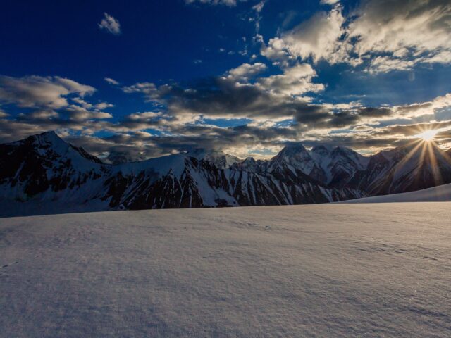 Trekkers near the snow-covered Gondogoro La pass in the Karakoram, Gilgit-Baltistan