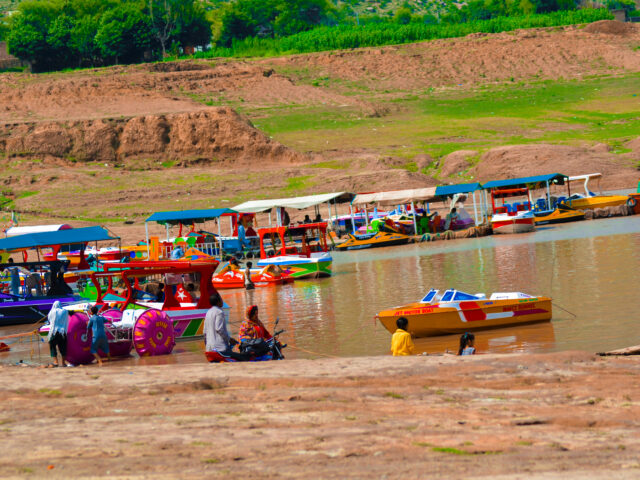 Boats on Khanpur Lake near Haripur with hills around the reservoir