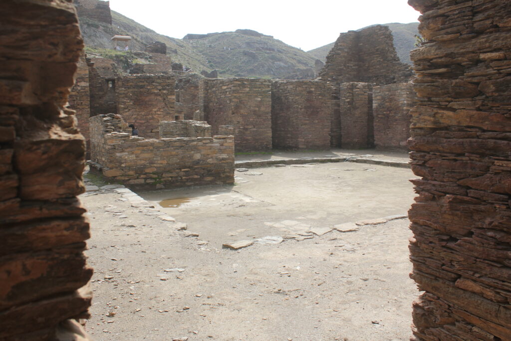 Ruined walls and chambers of the Takht-i-Bahi Buddhist monastery on its hilltop