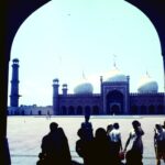 Visitors walking across the courtyard of Badshahi Mosque in Lahore